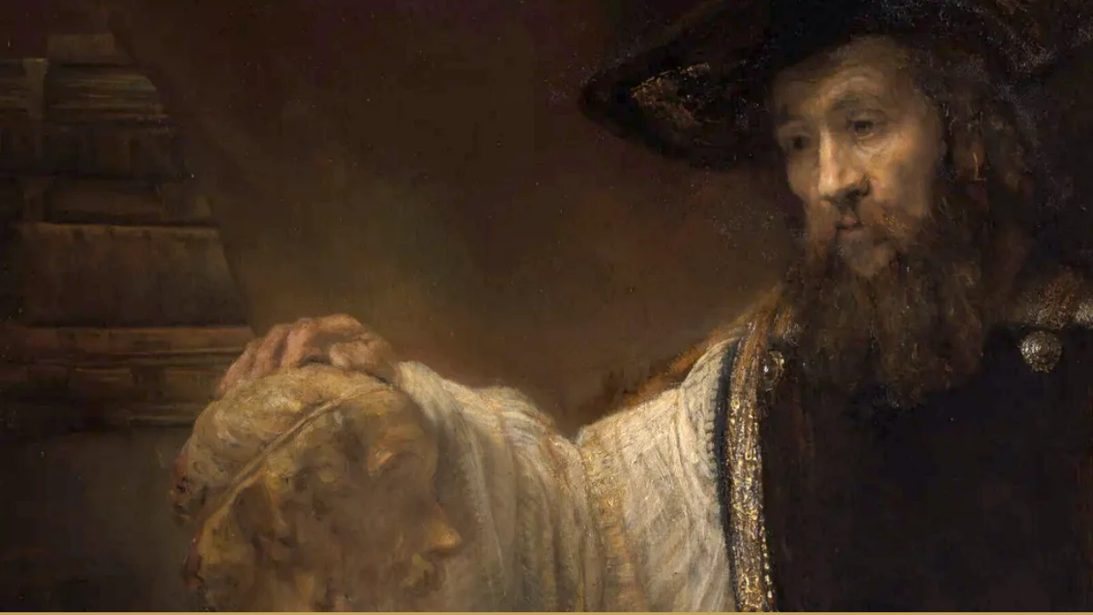 Detail of a Rembrandt painting: a bearded man in a wide black hat and white sleeves rests his hand on a marble bust, shelved books behind him.