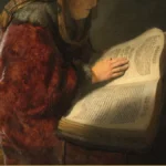 Detail of a Rembrandt painting: a figure in a deep red robe stands at a lectern with one hand resting on a large open printed book.
