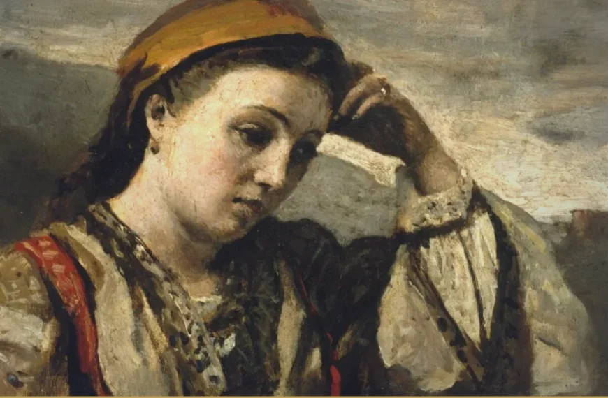 A young woman in a headscarf and embroidered blouse rests her head against one hand, eyes lowered, leaning on a stone wall under a grey sky.