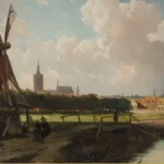 Painted view of a Dutch town on the horizon with church towers, a windmill, a towpath with small walking figures, a wooden footbridge and a canal under a cloudy sky.