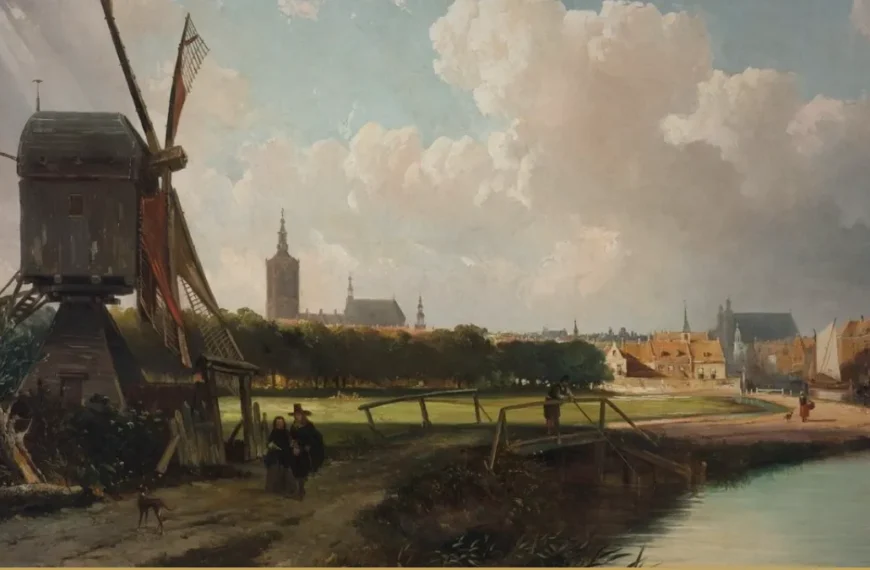 Painted view of a Dutch town on the horizon with church towers, a windmill, a towpath with small walking figures, a wooden footbridge and a canal under a cloudy sky.