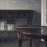 An empty living room painted in grey: folding doors stand open onto a back room with a closed piano, and a dark polished table fills the foreground.